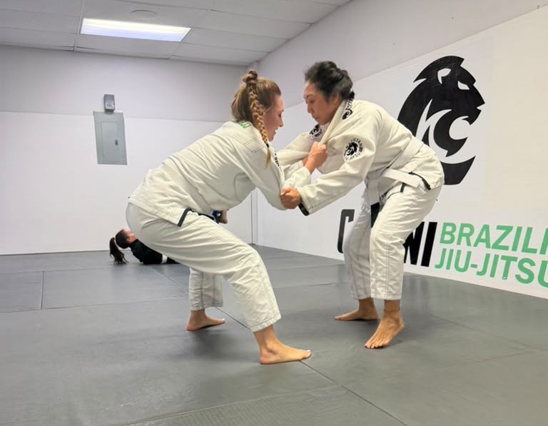 Jiu-Jitsu student executing side control escape during blue belt requirements practice at Magnolia academy